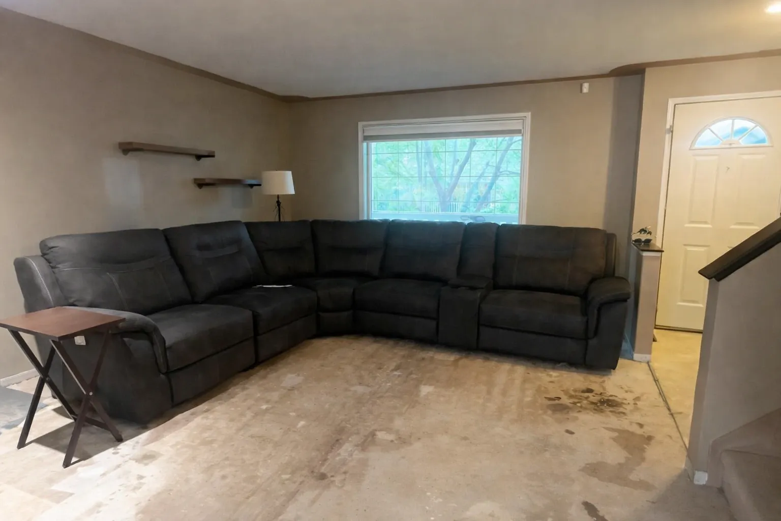 Living room before renovation with exposed subfloor in a Calgary home